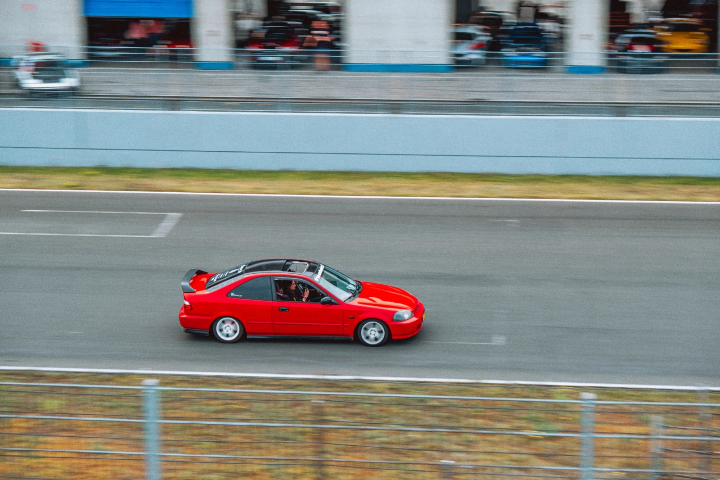 Red Honda Civic coupe in a panning shot