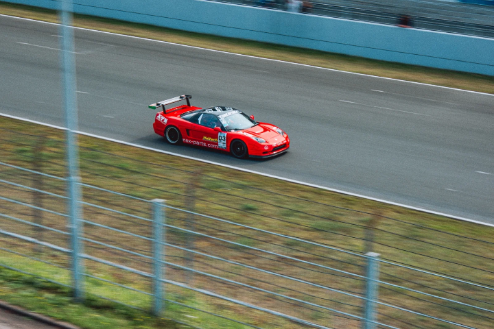 Red Honda NSX race car accelerating down the straight