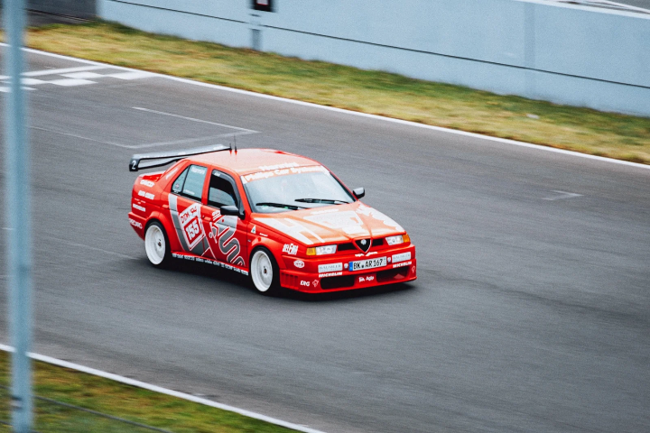 Red-and-white Honda Civic hatchback on track