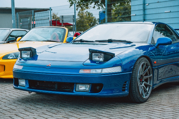 Blue Mitsubishi 3000GT with pop-up headlights raised