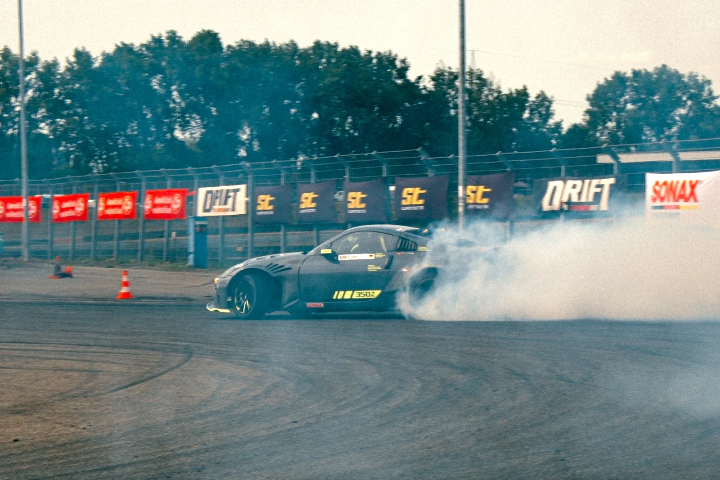 Widebody drift car disappearing into tyre smoke