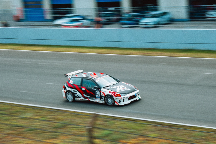 Black-and-red race hatchback with a large rear wing
