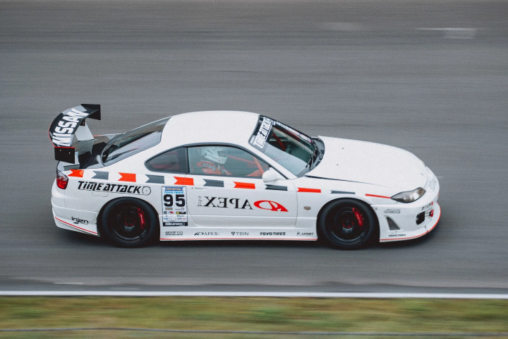 White BMW race coupe with an oversized rear wing