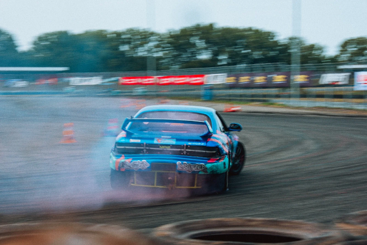 Blue drift car sliding through the smoke