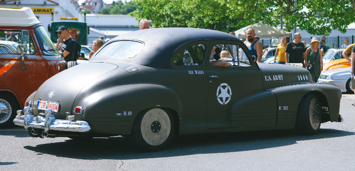 Dark green vintage military-style car with white star markings, displayed outdoors in Kulmbach