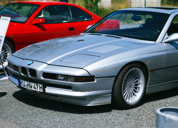 Silver BMW 8 Series E31 coupe with distinctive low front end and multi-spoke alloy wheels at Kulmbach